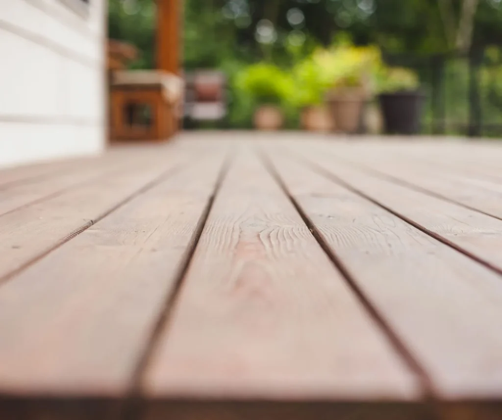 Perspective view of smooth, light brown wooden deck planks.